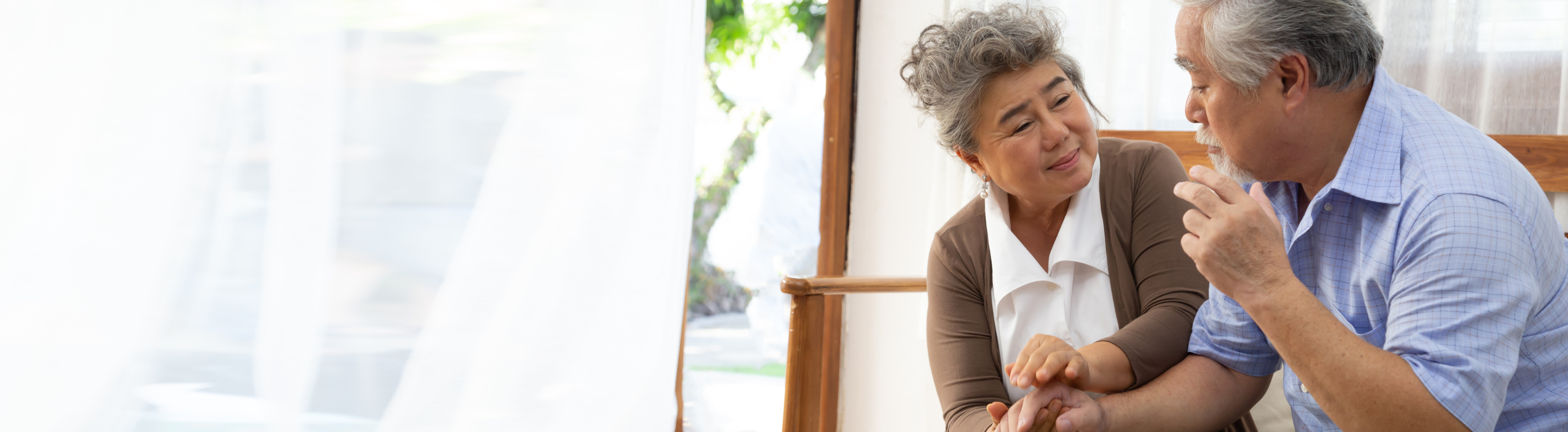 Older women assisting older man